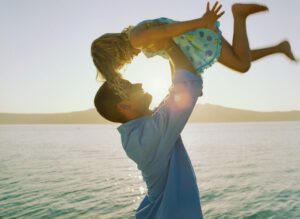 Man Lifting Daughter Into Air